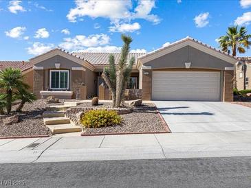 Charming single-story home showcasing desert landscaping and a two-car garage at 10417 Sea Palms Ave, Las Vegas, NV 89134