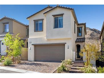 Charming two-story home showcasing a neutral exterior and a convenient two-car garage at 11652 Desert Hollow Ave, Las Vegas, NV 89138
