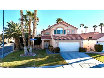 Charming two-story home with a well-maintained lawn and mature trees in a sunny neighborhood at 1515 Fort Dix Cir, North Las Vegas, NV 89031