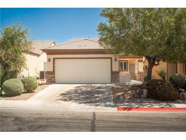 Charming single-story home featuring a two-car garage, desert landscaping, and a welcoming entrance at 2708 Cheer Pheasant Ave, North Las Vegas, NV 89084
