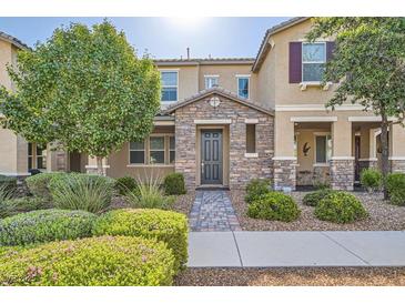 Charming two-story home with stone accents, a well-manicured yard, and a welcoming front entrance at 2878 Via Firenze, Henderson, NV 89044