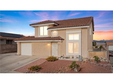 Charming two-story home featuring a tile roof, well-kept landscaping, and an attached garage at 3008 Soledad Dr, Laughlin, NV 89029