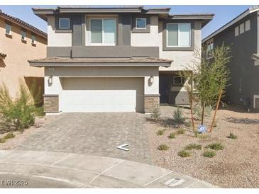 Two-story home featuring a neutral color scheme with a two car garage and desert landscaping at 330 Spring Dove Ave, Henderson, NV 89011
