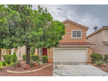 Charming two-story home featuring a well-manicured front yard with a mature shade tree and a two-car garage at 3412 Crystal Tower St, Las Vegas, NV 89129