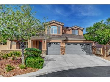 Charming two-story home with landscaped yard, three-car garage and desert landscaping at 3618 Auckland Castle St, Las Vegas, NV 89135