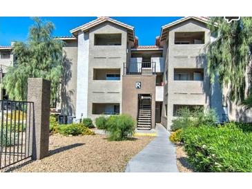 Condo building exterior featuring well-maintained landscaping and a walkway to the entrance at 4200 S Valley View Blvd # 2081, Las Vegas, NV 89103