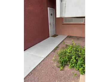 A close up of a condo entrance with a walkway and decorative security door at 4730 E Craig Rd # 1155, Las Vegas, NV 89115