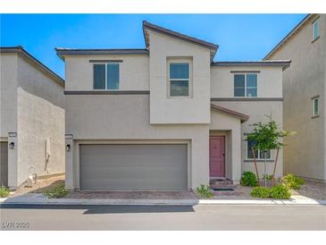 Contemporary two-story home with a two-car garage and desert landscaping at 6940 Crescent Gold St, North Las Vegas, NV 89086