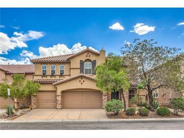 Charming two-story home with a three-car garage, mature landscaping, and a tile roof at 7095 Mountain Den Ave, Las Vegas, NV 89179