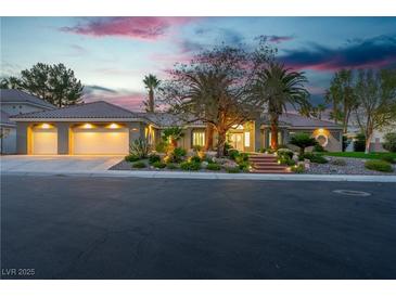 Beautiful single-story home featuring a three-car garage and desert landscaping at 7738 Willow Cove Cir, Las Vegas, NV 89129