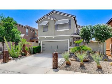 Inviting home showcasing a two-car garage and desert landscaping at 1017 Pebble Lake St, Henderson, NV 89011