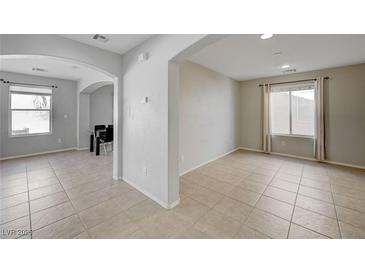 Bright living room features tile flooring, neutral paint, and plenty of natural light at 2586 Begonia Valley Ave, Henderson, NV 89074