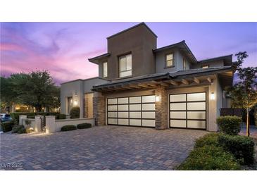 Stunning two-story home with a modern design, desert landscaping, and two-car garage at 6338 Skystone St, Las Vegas, NV 89135