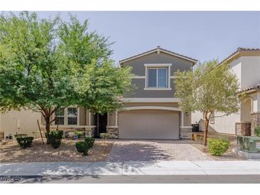 Charming home featuring a well-manicured lawn and a two-car garage at 6403 Ava Ridge Ave, Las Vegas, NV 89141