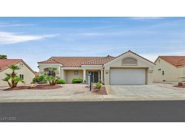Charming single-story home with a tile roof, desert landscaping, and an attached two-car garage at 8513 Festival Dr, Las Vegas, NV 89134