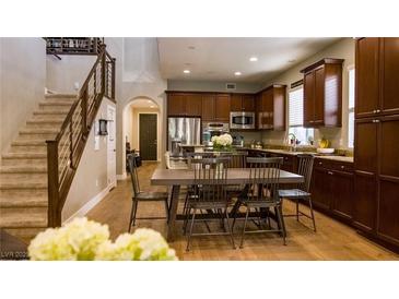 A view of a kitchen featuring stainless steel appliances, a center island, and dark wood cabinetry at 11731 Longworth Rd, Las Vegas, NV 89135