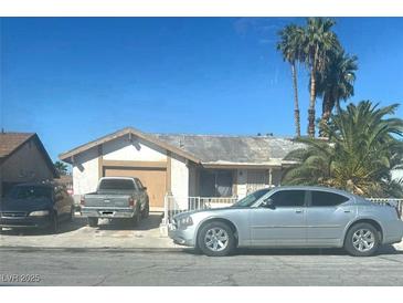 Single story home in a sunny area with driveway and palms at 132 Hillsway Dr, Las Vegas, NV 89110