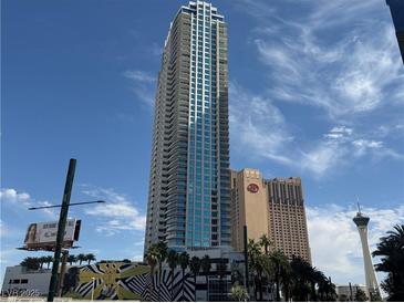 Striking high-rise condo building with expansive windows and balconies against a vibrant blue sky backdrop at 2700 Las Vegas Blvd # 2811, Las Vegas, NV 89109