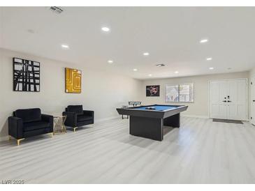 Spacious game room featuring a pool table, modern art, and stylish seating, perfect for entertaining at 3047 Van Buskirk Cir, Las Vegas, NV 89121