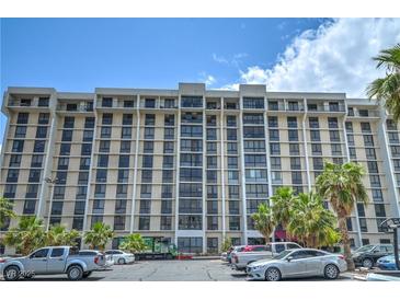 High-rise condominium building with multiple stories, balconies, and parking at 3930 University Center Dr # 706, Las Vegas, NV 89119