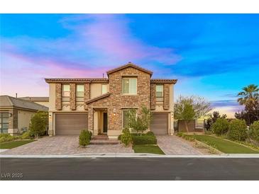 Stunning two-story home featuring stone accents, a three-car garage, and beautiful landscaping at 4702 Amazing View St, Las Vegas, NV 89129