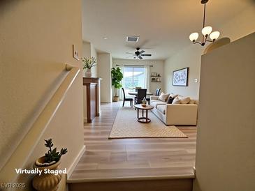 Inviting living room with an open layout features hardwood floors and lots of natural light at 6313 Snap Ridge St # 201, North Las Vegas, NV 89081