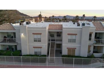 Exterior view of a multi-Gathering building with white stucco and desert landscaping at 6800 E Lake Mead Blvd # 1126, Las Vegas, NV 89156