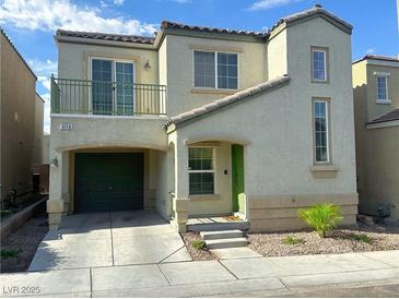 Charming two-story home featuring stucco siding, a small balcony, and an attached garage at 9116 Tailor Made Ave, Las Vegas, NV 89149