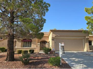 Charming single-story home featuring a well-manicured front yard and attached two-car garage at 9329 Fresh Spring Dr, Las Vegas, NV 89134