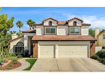 Charming two-story home with a well-manicured lawn and a spacious two-car garage at 2036 Deer Springs Dr, Henderson, NV 89074