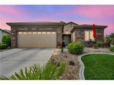 Charming home with a stone facade, well-manicured lawn, and a two-car garage at 2621 Icy Moon St, Henderson, NV 89044