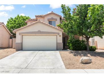 Charming two-story home featuring a two-car garage and low maintenance landscaping at 5 Spur Cross Cir, Henderson, NV 89012