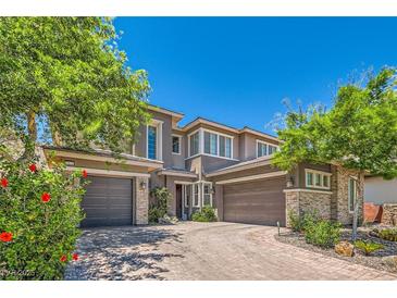 Beautiful two-story home with a three-car garage and well-manicured landscaping at 5879 Sky Heights Ct, Las Vegas, NV 89135