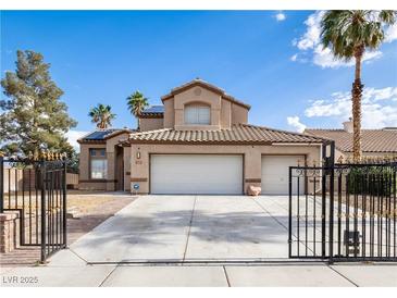Charming two-story home featuring a three-car garage, desert landscaping, and a gated entrance at 6101 Browning Way, Las Vegas, NV 89130