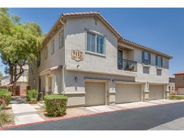 Charming townhome with a private balcony and attached garages in a well-maintained community at 9112 Canoga Canyon Ct # 103, Las Vegas, NV 89149