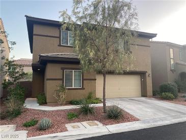 Charming two-story home featuring a neutral color scheme, a two-car garage and well-manicured landscaping at 10537 Thor Mountain Ln, Las Vegas, NV 89166