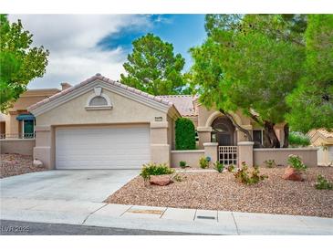 Charming single-story home with a well-maintained desert landscape and a spacious two-car garage at 10646 Heritage Hills Dr, Las Vegas, NV 89134