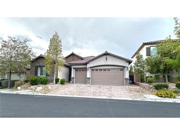 Charming single-story home with a brick driveway and a two-car garage at 10719 Hammett Park Ave, Las Vegas, NV 89166