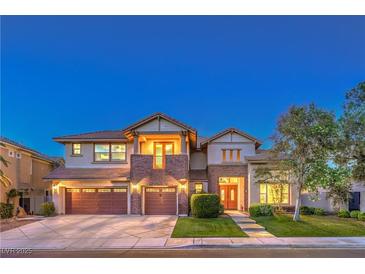 Elegant two-story home featuring a three-car garage, brick accents, and well-manicured landscaping at 2982 Hammerwood Dr, Las Vegas, NV 89135