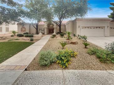 Charming single-story home featuring a well-manicured front yard and a two-car garage at 3957 Placita Del Lazo, Las Vegas, NV 89120