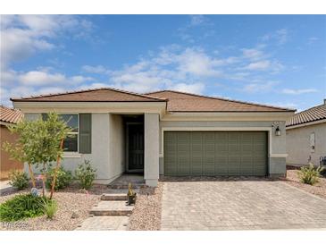 Charming single-story home with a two-car garage and a beautifully landscaped front yard at 4293 Nopal Serrano Ave, Las Vegas, NV 89141