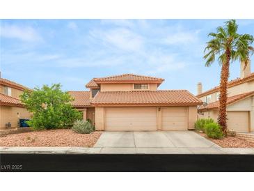 Charming two-story home featuring a three-car garage and a well-maintained, landscaped front yard at 7544 Shangri La Ave, Las Vegas, NV 89147