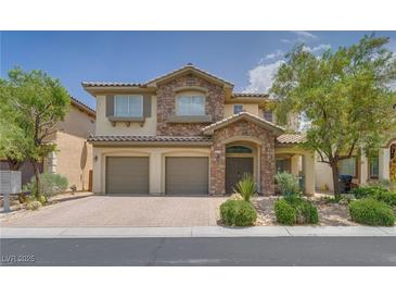 Charming two-story home featuring a stone facade, well-maintained landscaping, and a three-car garage at 9792 Crescent Lodge Ct, Las Vegas, NV 89178