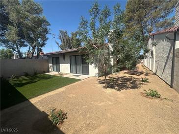 Spacious backyard featuring gravel ground cover and a small section of artificial grass at , Las Vegas, NV 89121