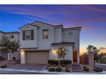 Charming two-story home showcasing its architectural design and well-manicured front yard at dusk at 10300 Stroma Ave, Las Vegas, NV 89166