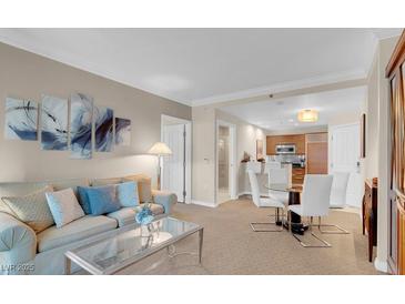 Relaxing living room featuring comfortable seating, neutral tones and easy access to the kitchen and dining area at 135 E Harmon Ave # 1621, Las Vegas, NV 89109