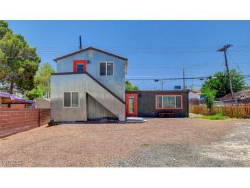 Unique modern two-story home with corrugated metal siding and contrasting orange doors at 1708 Cedar Ave, Las Vegas, NV 89101