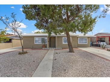 Charming single-story home featuring desert landscaping and mature shade trees at 2408 Berkley Ave, Las Vegas, NV 89101
