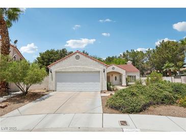 Charming single-story home with a well-manicured lawn and a two-car garage at 3201 Beacon Shores Cir, Las Vegas, NV 89117