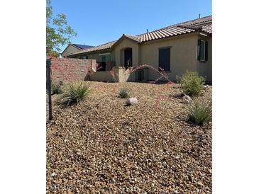 Landscaped front yard with decorative rock, shrubs, and desert plants at 3484 Bradano Ln, Henderson, NV 89044